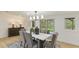 Bright dining room featuring modern lighting, neutral walls, and sliding door access to the patio at 3348 S Seclusion Dr, Sarasota, FL 34239