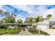 Charming two-story home featuring a well-manicured lawn with beautiful palm trees at 3348 S Seclusion Dr, Sarasota, FL 34239