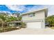 Charming exterior featuring well-maintained siding, a spacious garage, and beautiful landscaping at 3348 S Seclusion Dr, Sarasota, FL 34239