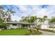 Charming home with manicured lawn, flowering plants, and tasteful landscaping enhancing the property's curb appeal at 3348 S Seclusion Dr, Sarasota, FL 34239