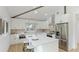Modern kitchen featuring white cabinets, stainless steel appliances, and a cozy breakfast bar at 3348 S Seclusion Dr, Sarasota, FL 34239