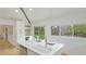 Bright kitchen with island, stainless appliances, and light wood floors overlooking a yard at 3348 S Seclusion Dr, Sarasota, FL 34239