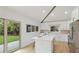 Bright, updated kitchen with white cabinets, stainless appliances, and access to the backyard at 3348 S Seclusion Dr, Sarasota, FL 34239