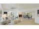 Bright living room with modern decor, wood floors, and an open floor plan to the dining area at 3348 S Seclusion Dr, Sarasota, FL 34239