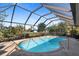 Backyard pool with a screened-in lanai, surrounded by a concrete deck and lush greenery at 339 Rio De Janeiro Ave, Punta Gorda, FL 33983