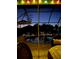 Night view of the pool with overhead string lighting and seating within the screened-in enclosure at 339 Rio De Janeiro Ave, Punta Gorda, FL 33983