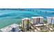 A picturesque building close to the waterfront with beautiful clear skies, palm trees, and boat docks at 378 Golden Gate Pt # 6, Sarasota, FL 34236