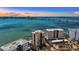 Stunning aerial view of a beachfront property with ocean views and a bridge in the background at 378 Golden Gate Pt # 6, Sarasota, FL 34236