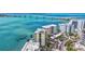 Beautiful waterfront building with a view of the bridge, palm trees, docks and boat slips at 378 Golden Gate Pt # 6, Sarasota, FL 34236