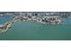 Aerial view showcasing waterfront condos, lush landscapes, docks, and waterways with boats at 378 Golden Gate Pt # 6, Sarasota, FL 34236