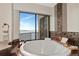 Bright bathroom with a round tub that features stunning water views and stylish tiling at 378 Golden Gate Pt # 6, Sarasota, FL 34236