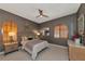 Serene bedroom with elegant gray walls, arched windows with wooden shutters, and stylish furnishings at 378 Golden Gate Pt # 6, Sarasota, FL 34236