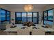 Chic dining area with modern table, chandelier and serene view of the water at 378 Golden Gate Pt # 6, Sarasota, FL 34236