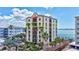 Multi-story condominium building featuring multiple balconies, waterfront views, and tropical landscaping at 378 Golden Gate Pt # 6, Sarasota, FL 34236