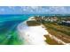 A stunning aerial photograph of a white sandy beach with clear turquoise water and blue skies at 3939 Higel Ave, Sarasota, FL 34242