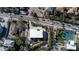 Birds eye view of coastal home with palm trees, a tennis court, and modern architecture at 3939 Higel Ave, Sarasota, FL 34242