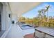 Spacious balcony with a private plunge pool and outdoor dining area overlooking lush landscaping at 3939 Higel Ave, Sarasota, FL 34242