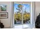 Balcony view from the main bedroom, showcasing lush greenery and tropical trees at 3939 Higel Ave, Sarasota, FL 34242