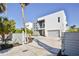 Modern two-story home with gray fencing, a gray and white facade, balcony, and gray garage door at 3939 Higel Ave, Sarasota, FL 34242