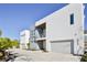 Contemporary home with a two-story facade, balcony, and gray driveway, showcasing modern curb appeal at 3939 Higel Ave, Sarasota, FL 34242