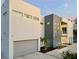 Modern two-story home with gray accents, security cameras, and a professionally landscaped front yard at 3939 Higel Ave, Sarasota, FL 34242