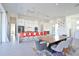 Modern kitchen and dining area with sleek cabinets, an island with seating, and an open layout for entertaining at 3939 Higel Ave, Sarasota, FL 34242