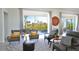 Relaxing living room with modern furniture, a geometric rug, and an open view to the balcony and pool area at 3939 Higel Ave, Sarasota, FL 34242