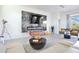 Modern living room featuring a stone accent wall with a fireplace and TV, plus stylish furniture and decor at 3939 Higel Ave, Sarasota, FL 34242