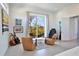 Inviting main bedroom seating area with stylish decor, artwork, and access to the balcony at 3939 Higel Ave, Sarasota, FL 34242