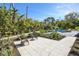 Beautiful outdoor patio area with lush landscaping and comfortable seating at 3939 Higel Ave, Sarasota, FL 34242
