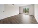 Bright bedroom featuring wood laminate flooring, a large window, and neutral-colored walls at 4001 Beneva Rd # 304, Sarasota, FL 34233