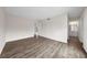 A bright bedroom featuring wood laminate flooring and access to an adjacent bathroom with a large doorway at 4001 Beneva Rd # 304, Sarasota, FL 34233