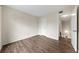 Empty bedroom featuring wood laminate floors, a neutral color scheme and closet at 4001 Beneva Rd # 304, Sarasota, FL 34233