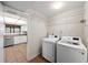 Practical laundry area with modern appliances conveniently located near kitchen at 4001 Beneva Rd # 304, Sarasota, FL 34233