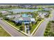 Aerial view showcasing clubhouse, pool, and scenic lake in the community at 4514 Big Woods Way, Parrish, FL 34219