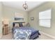 Well-lit bedroom featuring wood decor, a large window, and a comfortable bed with decorative pillows at 4514 Big Woods Way, Parrish, FL 34219