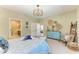 Bright bedroom with a full bathroom, decorative chandelier, and large window at 4514 Big Woods Way, Parrish, FL 34219