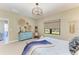 Airy bedroom featuring a decorative chandelier, neutral walls, and large window at 4514 Big Woods Way, Parrish, FL 34219