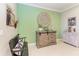Interior shot of home featuring green wall, bench, wood storage cabinet, and home decor at 4514 Big Woods Way, Parrish, FL 34219