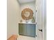 Hallway featuring vanity with wooden mirror above a green cabinet and white door at 4514 Big Woods Way, Parrish, FL 34219
