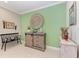 Interior shot of home featuring green wall, bench, wood storage cabinet, and home decor at 4514 Big Woods Way, Parrish, FL 34219