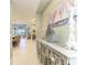 Bright hallway featuring tile floors, decorative furniture, and an open view to the kitchen and living room at 4514 Big Woods Way, Parrish, FL 34219