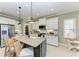 Kitchen featuring granite counters, stainless steel appliances, and a large central island with seating at 4514 Big Woods Way, Parrish, FL 34219