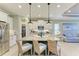 Kitchen with a large island with granite countertops, pendant lighting, stainless steel appliances, and seating at 4514 Big Woods Way, Parrish, FL 34219