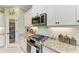 Close up on kitchen featuring stainless steel range, granite countertops and tiled backsplash at 4514 Big Woods Way, Parrish, FL 34219