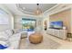 Open living room featuring coffered ceilings and sliding glass doors at 4514 Big Woods Way, Parrish, FL 34219