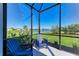 Screened-in patio with comfortable chairs offering peaceful water views at 4514 Big Woods Way, Parrish, FL 34219