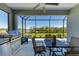 Covered patio boasting an outdoor kitchen, dining area, and serene lake views for entertaining at 4514 Big Woods Way, Parrish, FL 34219