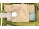 Aerial view of the house showcasing the tile roof, driveway, and screened-in pool at 5305 Brookgrove Dr, Sarasota, FL 34238