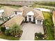 An aerial view shows a beautiful two-story home with tile roof, a large yard and a lake view at 5305 Brookgrove Dr, Sarasota, FL 34238